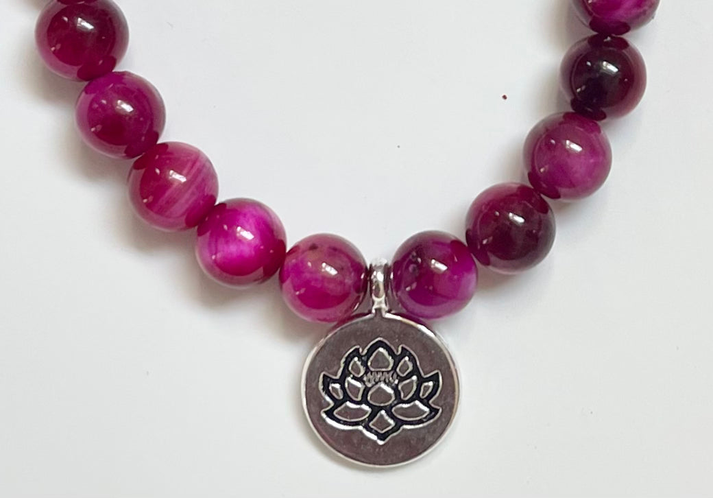 Close-up of magenta tiger eye beads jewelry