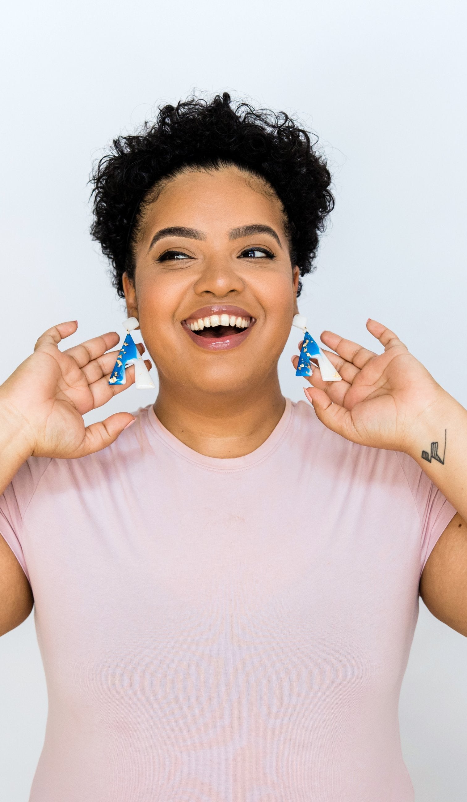 Girl smiling and showing off earrings