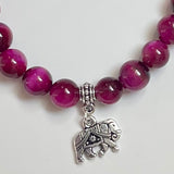 Close-up of magenta tiger eye beads jewelry