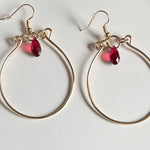 Gold wire hoop earrings with red crystal